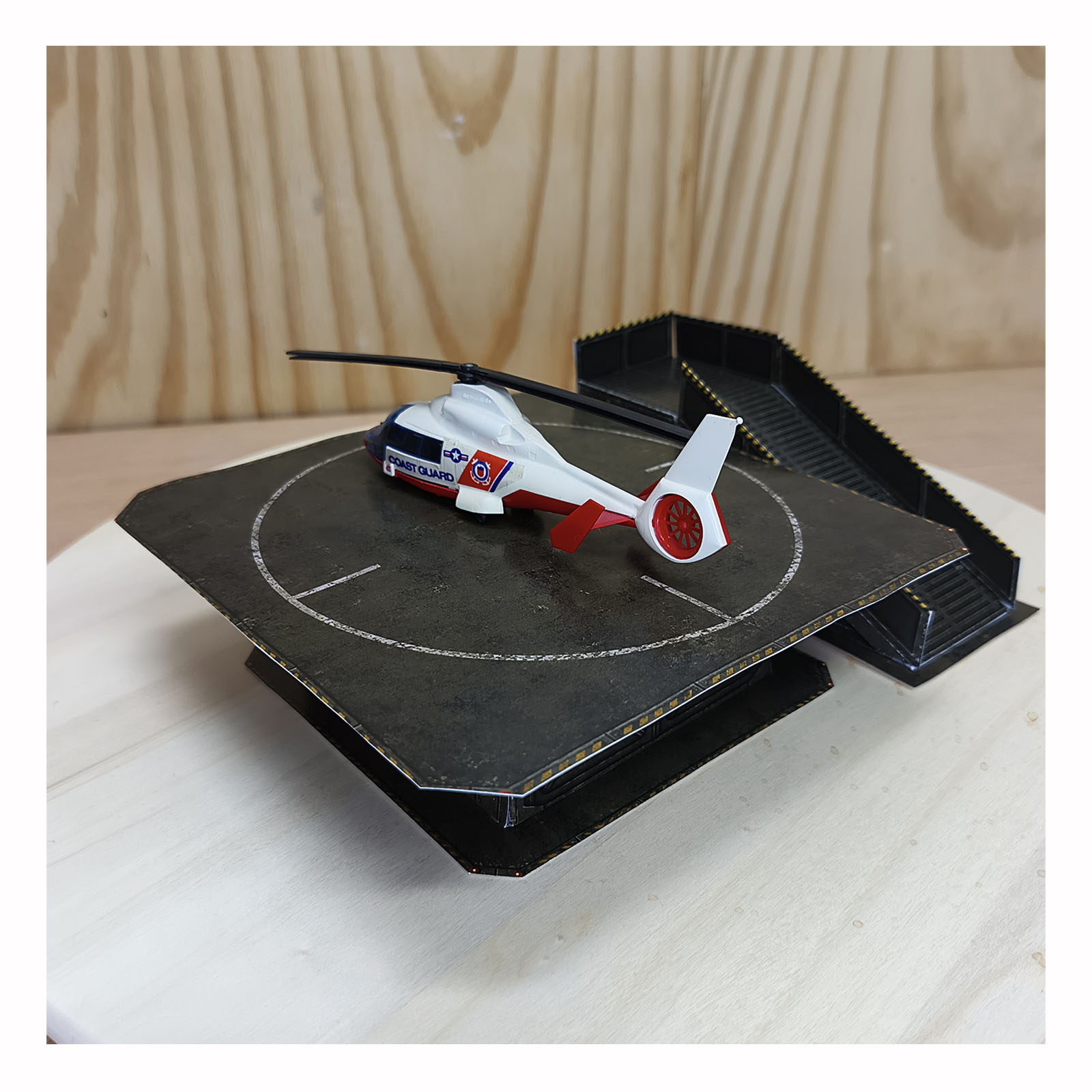 Completed Army Green helipad diorama with a red and white Coast Guard helicopter displayed on the landing platform