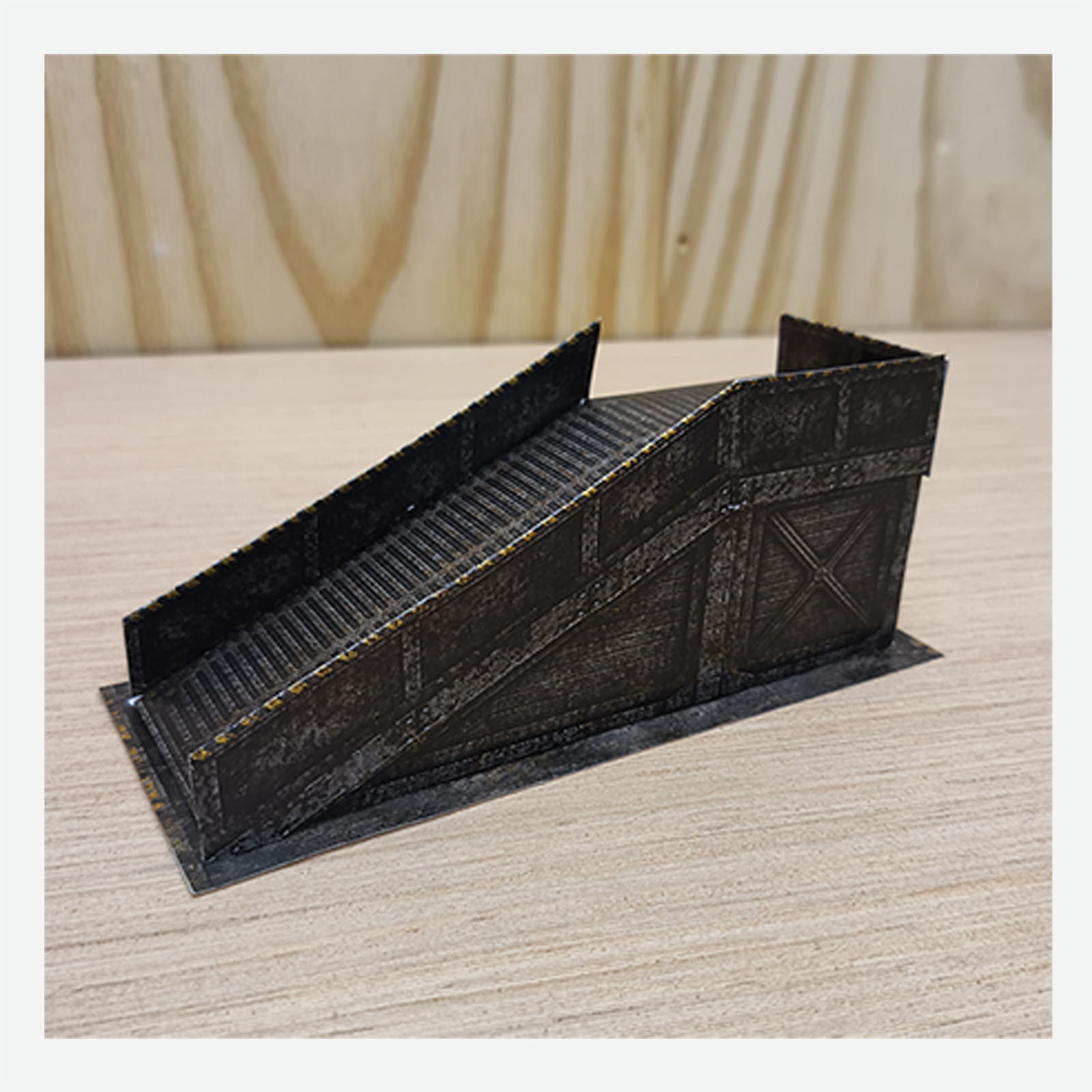 Close-up of the completed post-apocalyptic helipad access ramp showing the finished colors and miniature details