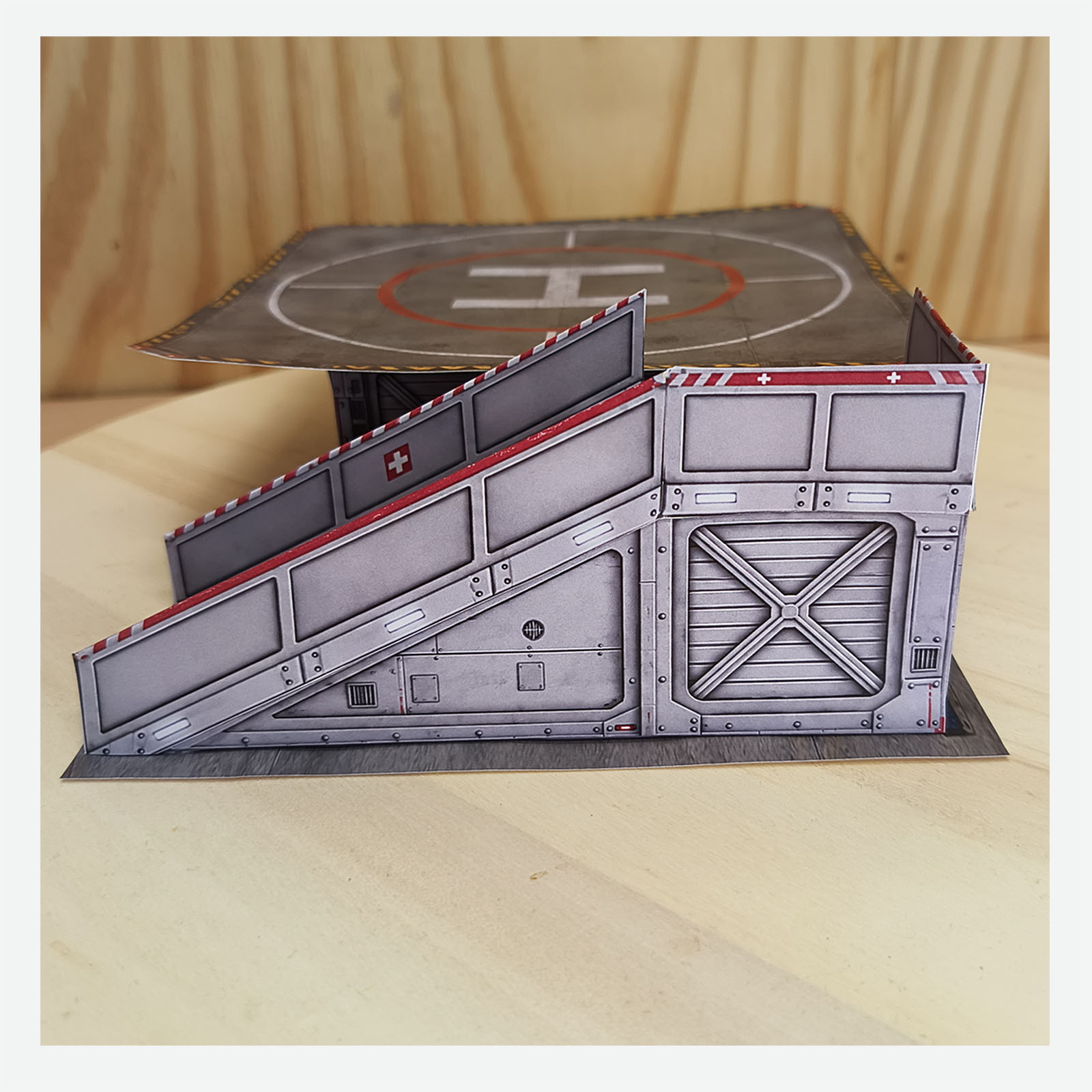 Close side view of the completed hospital helicopter display base focusing on the access ramp