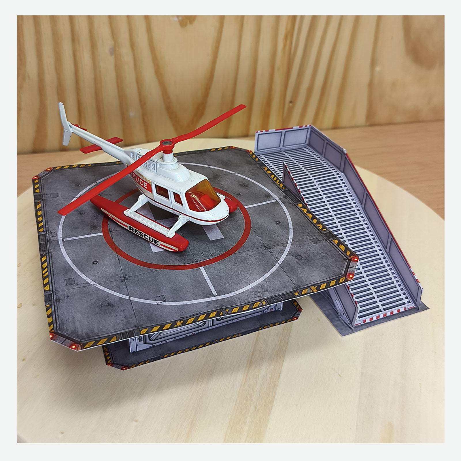 Completed hospital helipad diorama with a rescue helicopter displayed on the rooftop landing pad