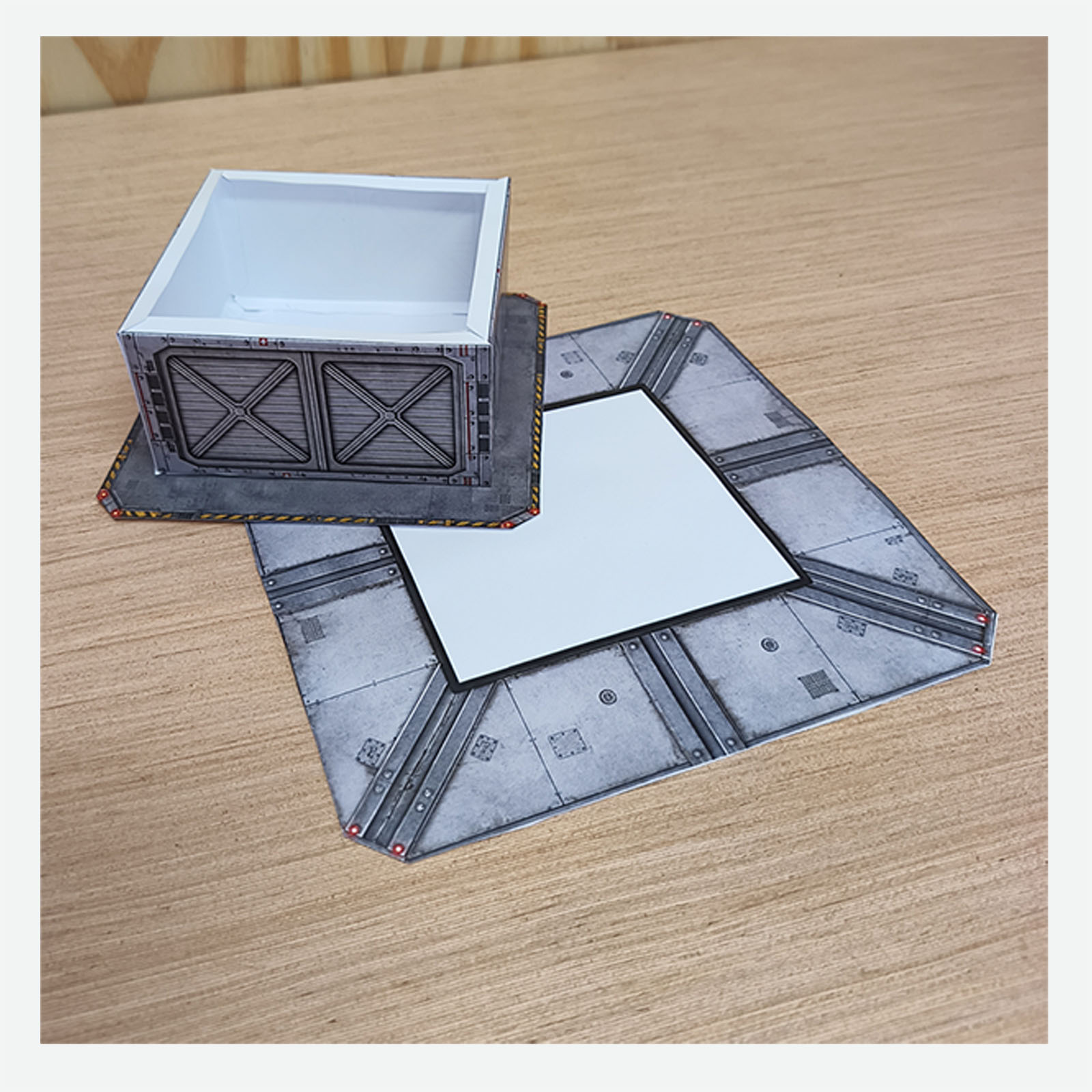 Partially assembled papercraft hospital helipad turned upside down to show how the pieces are glued together