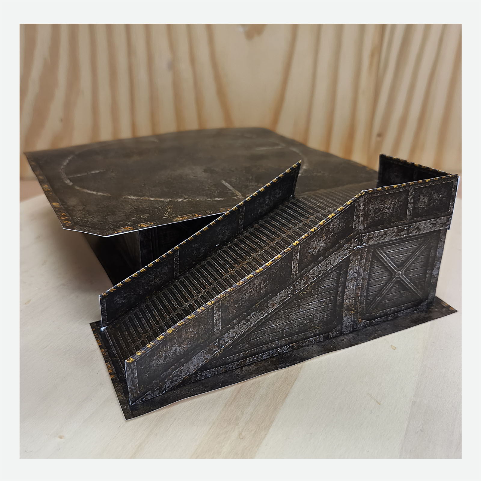 Completed post-apocalyptic papercraft helipad viewed in perspective with a close view of the detailed access ramp