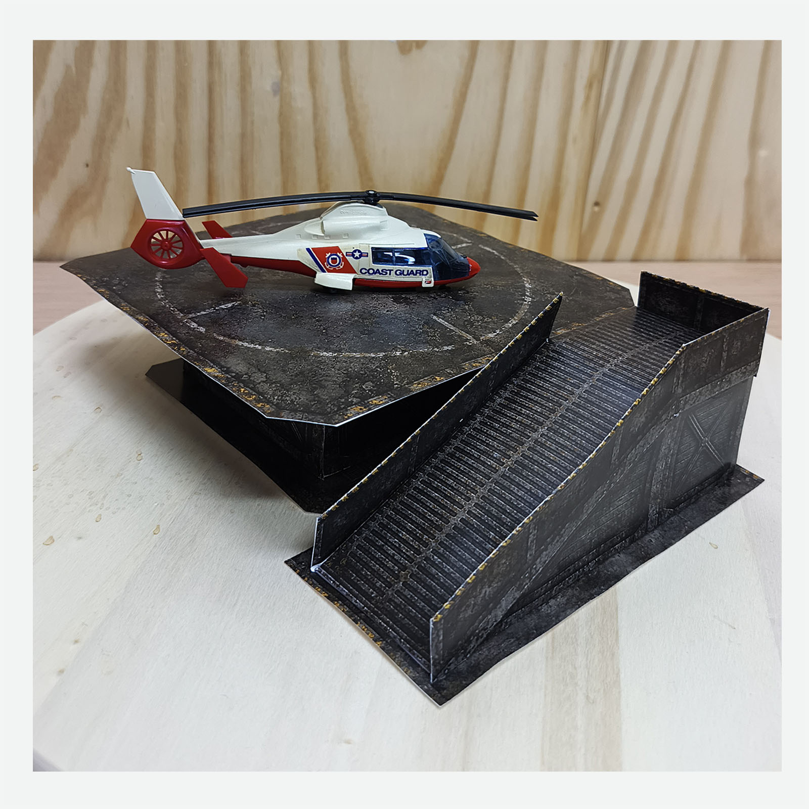 Completed post-apocalyptic helipad diorama with a red and white Coast Guard helicopter and the access ramp visible at the front
